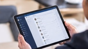 Someone holding a tablet showing a care management app